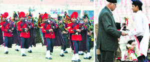 A military band performs during Beating Retreat at MA Stadium in Jammu on Wednesday; and (right) Governor NN Vohra gives a prize to a parade contingent. Tribune photos: Anand Sharma