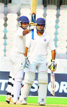Maharashtras Ankit Bawne raises the bat after completing his half-century against Karnataka in Hyderabad on Wednesday. 
