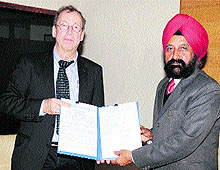 Prof Ajaib Singh Brar, Vice-Chancellor, GNDU, and Prof Bernhard Blumich, Director, Institute of Technical and Macromolecular Chemistry, RWTH AACHEN University, Germany, sign the MoU in Amritsar on Thursday