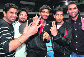 Players of the DAV College of Education, Fazilka, flash the victory sign after winning the inter-college championship at Panjab University in Chandigarh.