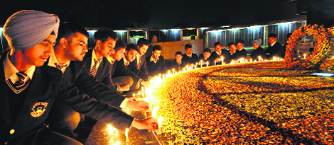 Students of Guru Nanak Public School, Sector 36, light candles at the war memorial in Sector 3, Chandigarh, on Thursday.
