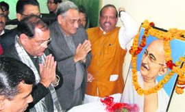 Uttarakhand Chief Minister Vijay Bahuguna and the state Congress president Yashpal Arya offer floral tributes to the Father of the Nation Mahatma Gandhi, at Congress Bhawan in Dehradun on Thursday.