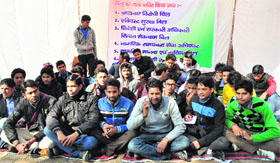 Students stage a protest in front of DAV PG College in Dehradun on Thursday.