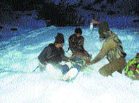 Army personnel give first aid to a civilian injured in an avalanche in Ramban district on Wednesday.