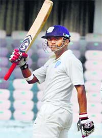 Karnataka opener Lokesh Rahul celebrates after completing his half century against Maharashtra on the second day of the Ranji Trophy final at Hyderabad on Thursday