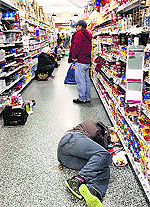 People rest at a grocery store after being stranded due to a snow storm in Atlanta