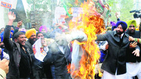 Members of the Youth Akali Dal burn an effigy of Congress vice-president Rahul Gandhi in Phase I, Mohali, on Friday.