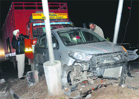 The damaged car after it was hit by a truck on the road separating Sector 31 and Industrial Area, Phase II, in Chandigarh on Friday. The two occupants of the car were injured in the accident.