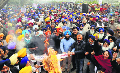 Youth Akali Dal activists burn an effigy during a protest in Amritsar on Friday.