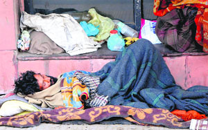 A beggar sleeps on a footpath in Amritsar.