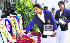 A student pays tributes to Kalpana Chawla on her 11th death anniversary in Karnal on Saturday.