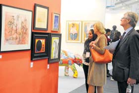Visitors admire the artwork on display during the fair in New Delhi on Saturday