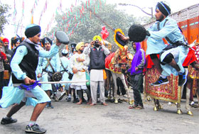 Sikh youths perform gatka during a Nagar Kirtan to mark the birth anniversary of Baba Deep Singh in Amritsar on Sunday.