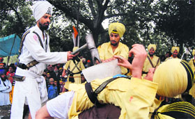 Youths perform gatka during a Nagar Kirtan on the birth anniversary of Baba Deep Singh in Amritsar on Sunday.