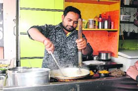 Shammi prepares food at his dhaba on Railway Road