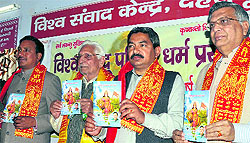 Members of the Vishwa Hindu Parishad release a book during a programme in Dehradun on Sunday