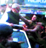 A TV grab of youth trying to slap Hooda