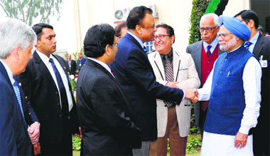Prime Minister Manmohan Singh meets scientists as Governor NN Vohra looks on at Raj Bhawan in Jammu on Sunday.