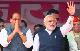 BJP prime ministerial candidate Narendra Modi with party president Rajnath Singh during the Vijay Shankhnaad rally at Meerut in Uttar Pradesh on Sunday