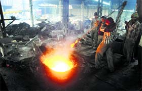 Workers at a furnace unit at the Focal Point, Phase VII, Ludhiana