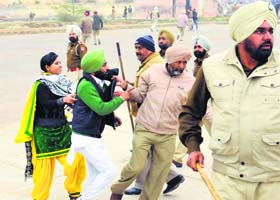 Police personnel detain protesting sikhya providers in Bathinda on Sunday