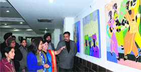 Artist Anuradha Thakur displays her work at KTKala art gallery in Amritsar on Monday.