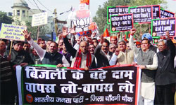 Delhi BJP president Vijay Goel with party activists raise slogans during a protest march in the walled city, Delhi on Monday. Tribune Photo