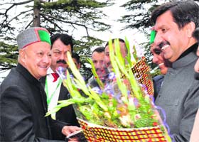 Chief Minister Virbhadra Singh being welcomed by Parliamentary Affairs Minister Mukesh Agnihotri during the first day of the Budget session in Shimla on Monday