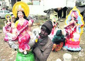 Art for lifes sake: On the eve of Basant Panchami, an artist gives final touches to an idol of goddess Saraswati in Jalandhar on Monday
