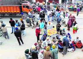 Protesters stage a dharna on a highway in Jagraon on Monday
