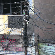 A view of a pole with electricity wires running criss-cross on Lawrence Road in Amritsar.