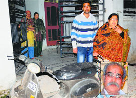 Family members of the victim, Subhash Chander (inset), outside their residence after the firing incident at Adarsh Colony in Nayagaon on Tuesday.