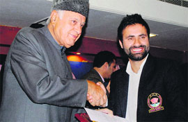 Union Minister for New and Renewable Energy Farooq Abdullah felicitates J&K team captain Parvez Rasool during a welcome party for Ranji team in Jammu on Tuesday.