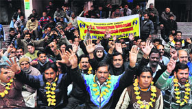 Members of the Public Health Engineering Welfare Association protest in Jammu on Tuesday.