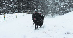 Children walk on a snow-covered area near the Mughal Road in Kashmir on Tuesday.