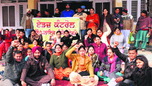 Members of the AIDS Control Employees Union hold a protest in Amritsar on Wednesday.