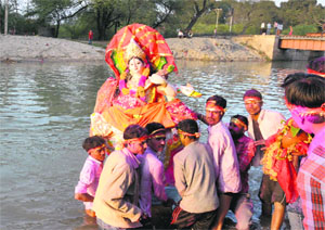 Devotees immerse an idol of Goddess Saraswati a day after Basant Panchami in Bathinda on Wednesday