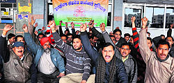 Roadways workers protest in support of their demands at the ISBT in Dehradun on Wednesday