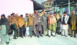 A group of stranded truck drivers from Pakistan-occupied Kashmir at the Trade Facilitation Centre, Salambad, Uri, on Wednesday. Tribune photograph