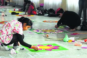 Students take part in a rangoli-making competition during the Inter-College Art and Literary Competitions at the Guru Nanak Khalsa College for Women in Ludhiana on Wednesday