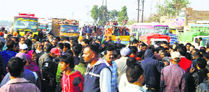 People block a road in protest in Ludhiana on Wednesday