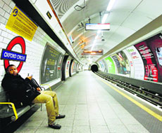 A passenger waits for a train that did not arrive on an empty platform during rush hour at Oxford Circus underground station in London on Wednesday.