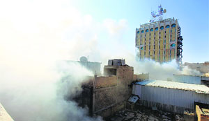 Smoke rises from the site of a bomb attack near Khilani Square in Baghdad on Wednesday.
