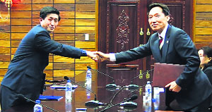 Head of the North Korean working-level delegation, Park Yong Il (L) and his South Korean counterpart Lee Duk-haeng in Panmunjom on Wednesday.