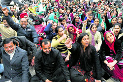 Employees of the National Rural Health Mission protest at Sector 22 in Chandigarh