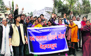 Members of Jan Swasthaya Sangharsh Morcha protest near the state Assembly against lack of health facilities in Dehradun on Thursday.
