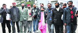 BJP MLAs with their mouth taped shut as they leave the Vidhan Sabha in Shimla on Wednesday. Photo: Amit Kanwar