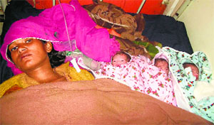 A woman with her triplets in a private hospital in Kaithal on Thursday.
