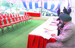 Officials await buyers for commercial properties during an auction in Jalandhar on Thursday. Photo: Sarabjit Singh
