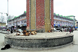 State of Neglect: Stray dogs rest on the plinth of the Clock Tower in the Lal Chowk area of Srinagar